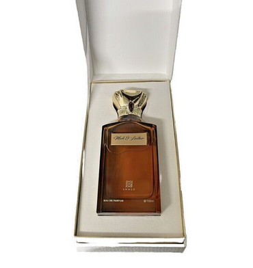 Brown perfume bottle with gold cap in a white box on a white background