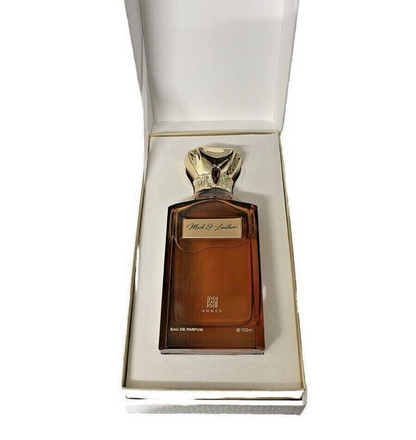 Brown perfume bottle with gold cap in a white box on a white background